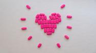 pink pills in the shape of a heart